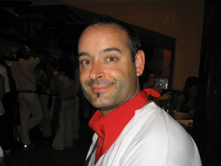 a man wearing a white shirt and red bow tie