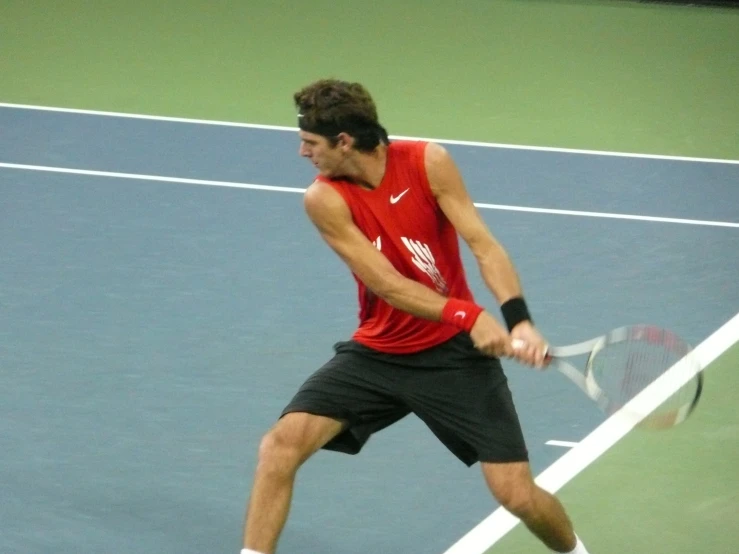 a man is playing tennis and ready to hit the ball