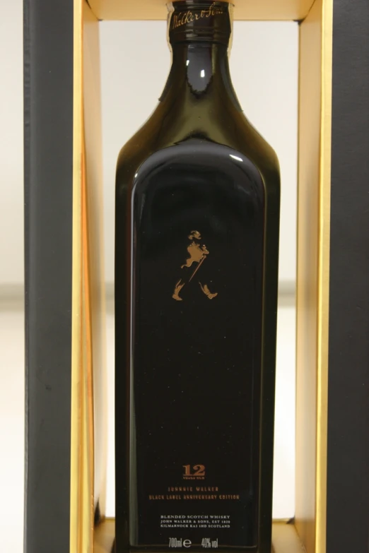 a bottle of wine with a gold logo in a wooden case