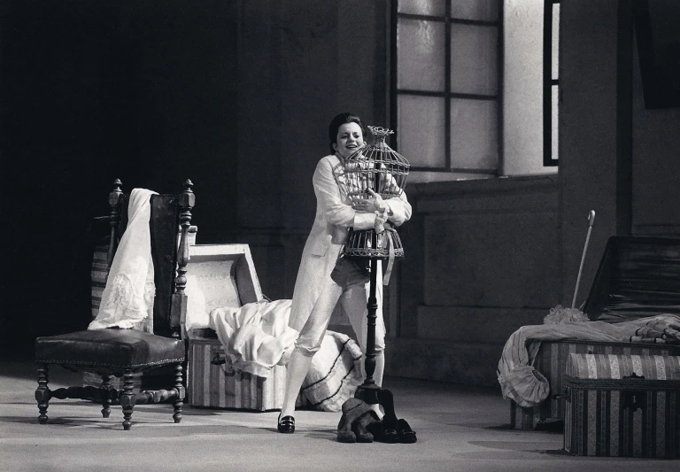 a woman poses in her living room with two old beds