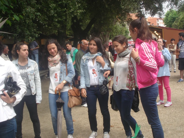 girls stand together and talk while others walk