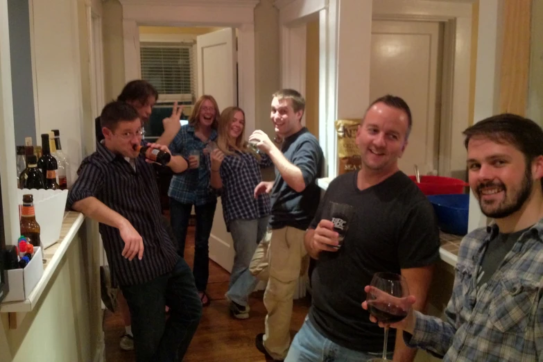 a group of people standing next to each other on a kitchen counter