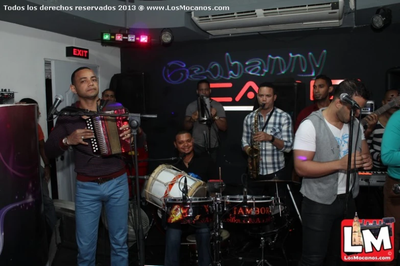 a group of men that are standing in front of some instruments