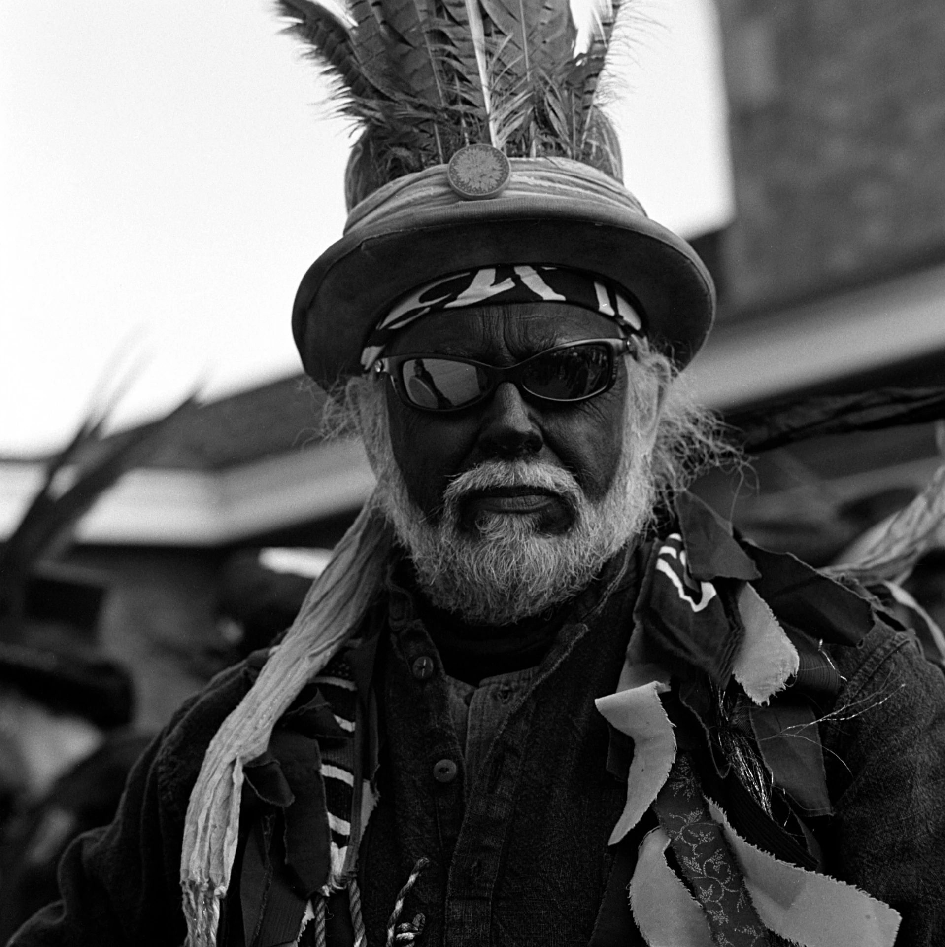 a man is dressed in native indian clothing and hat