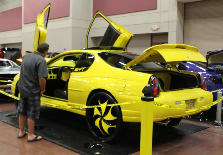 a guy checking out the cars in the showroom