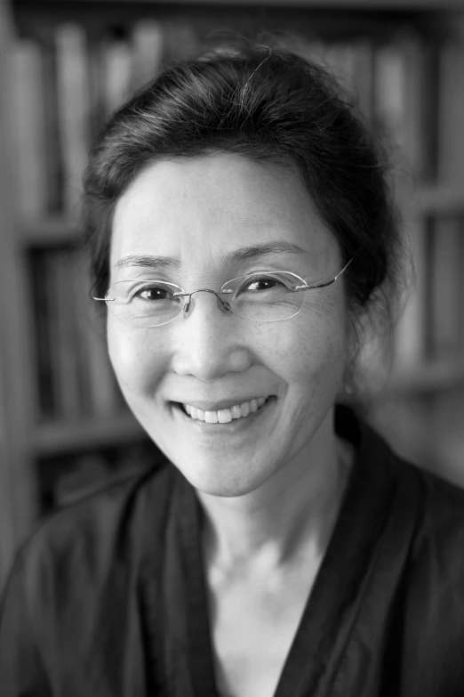 a woman in glasses smiling for the camera