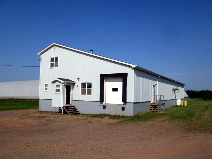 a white house with a garage is shown