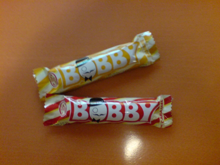 two wrapped bars with characters on them laying on a table