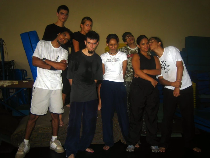 several people standing together in front of a wall