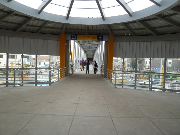 an open walkway that goes into the sky and is between buildings