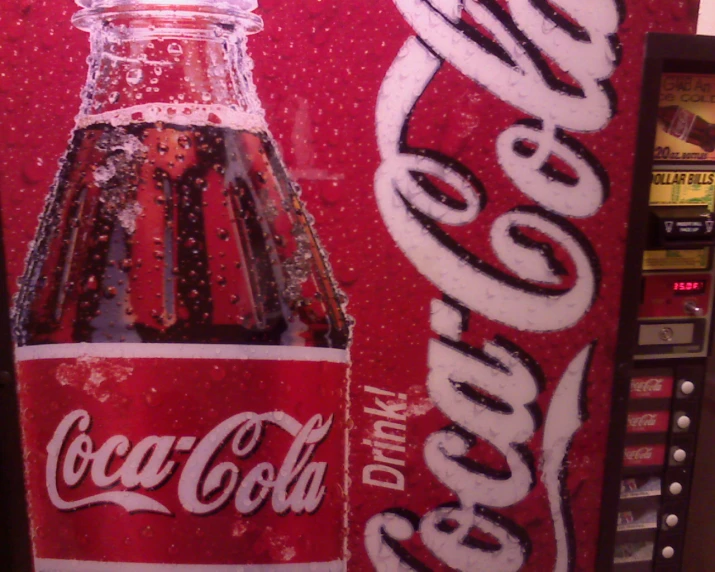 a coca cola machine with an open bottle