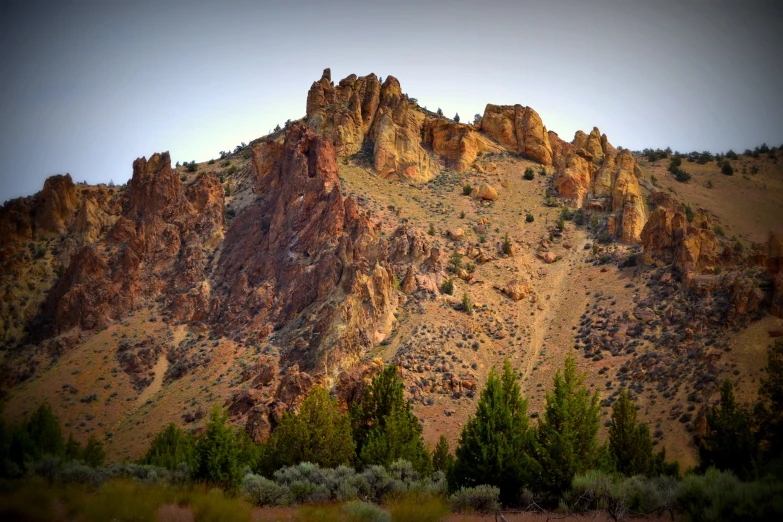 a very pretty mountain with some trees in the foreground