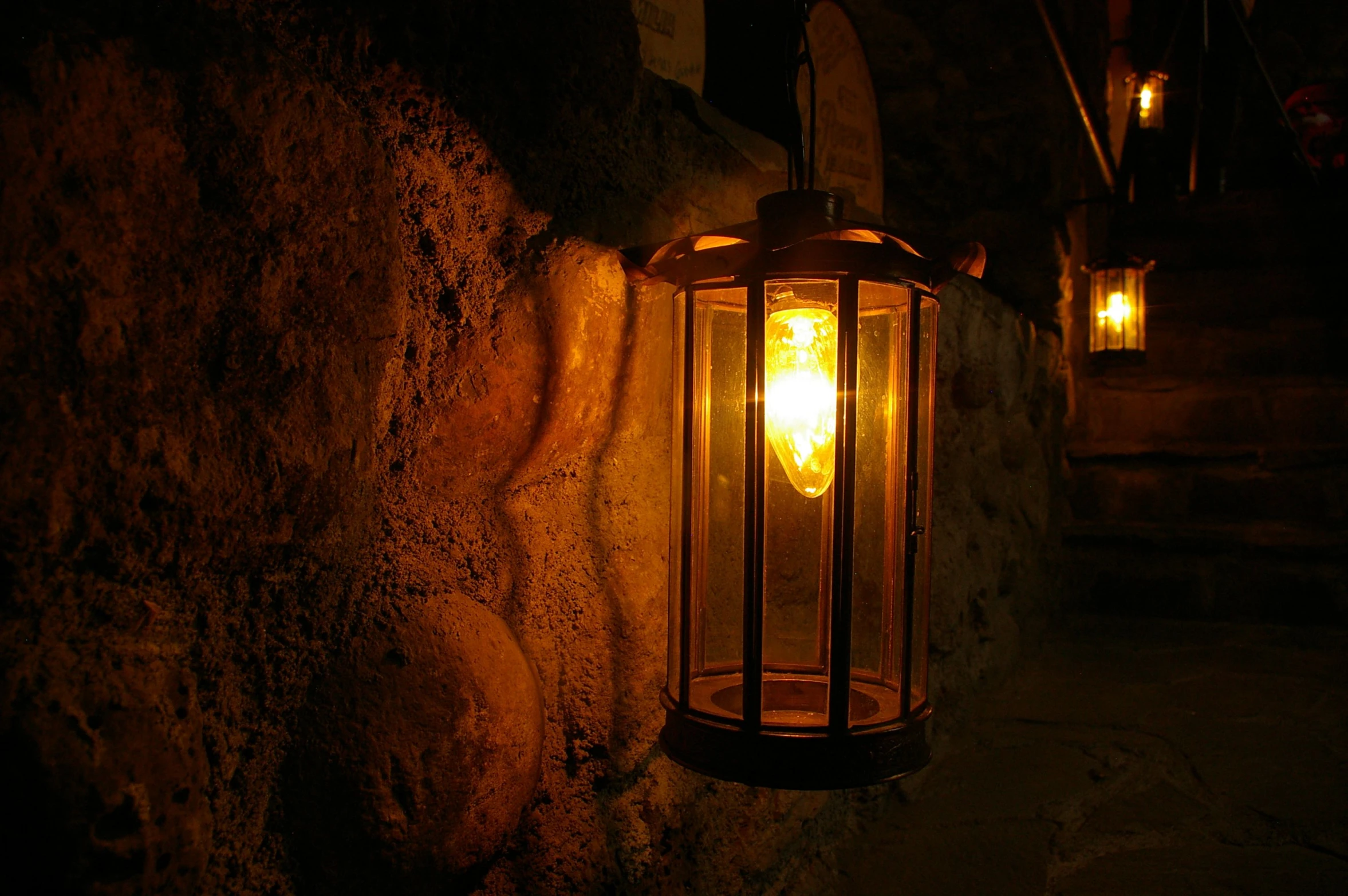 a lighted lantern sitting on the wall