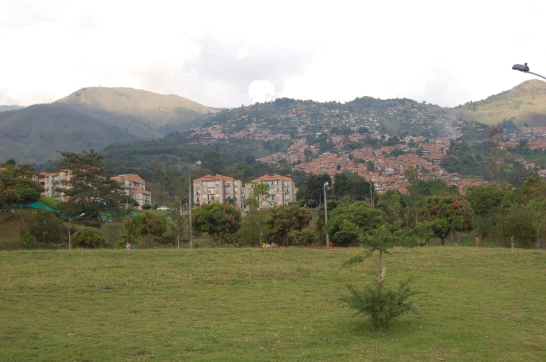 a town in the background with a kite above it