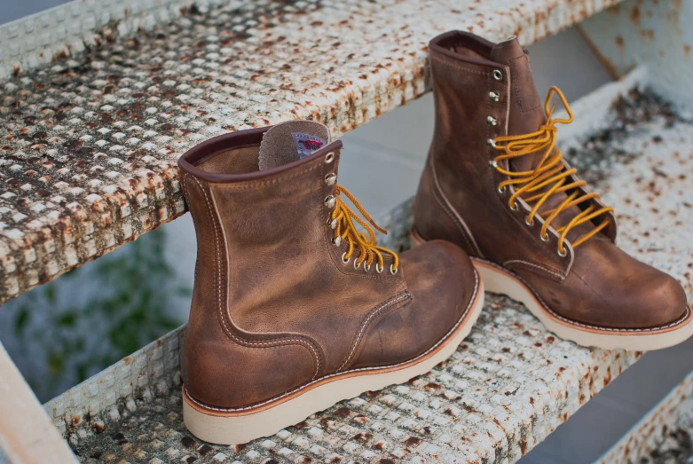 two brown boots sitting on top of stairs