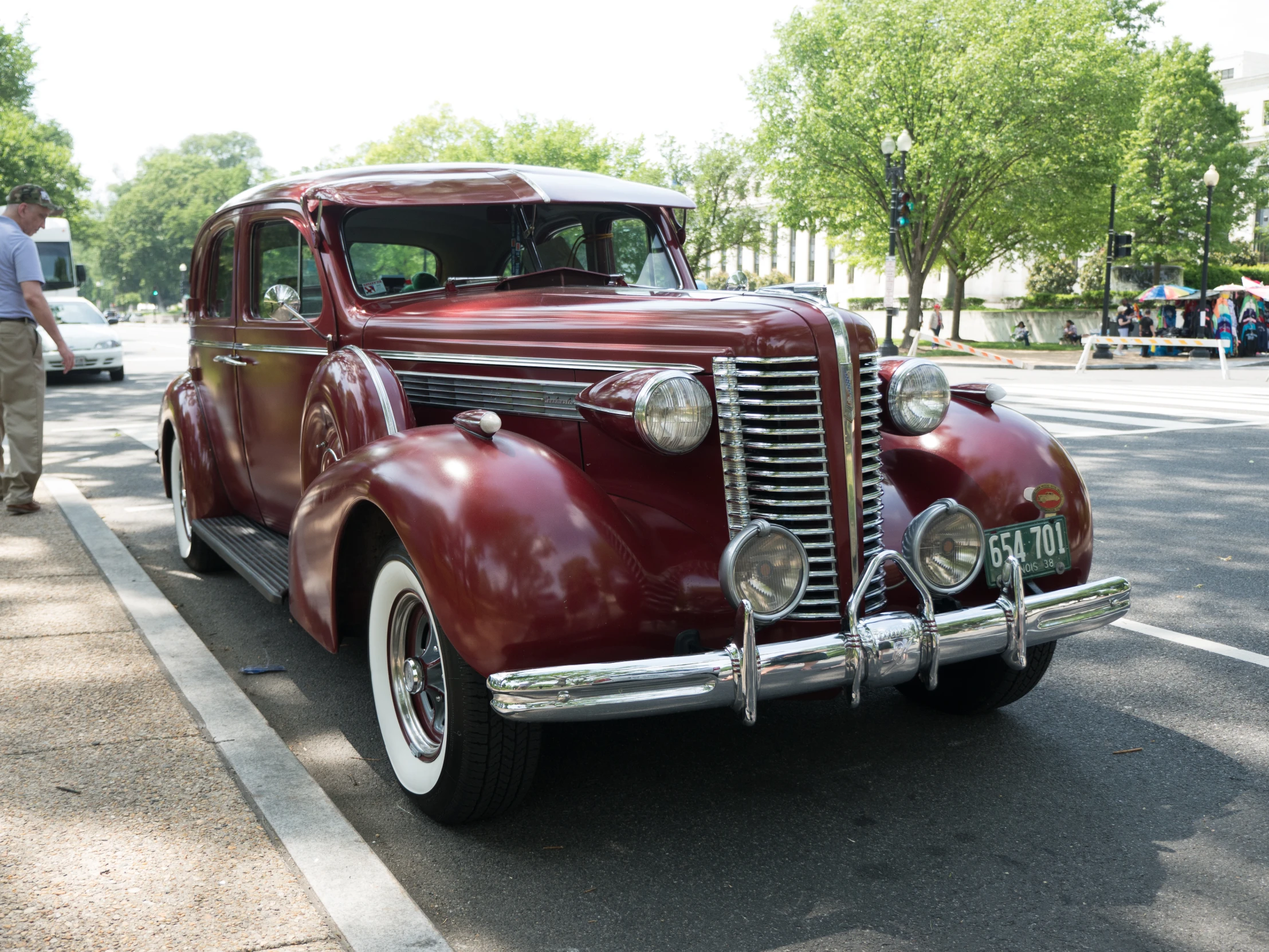 a brown classic car parked on the side of the road