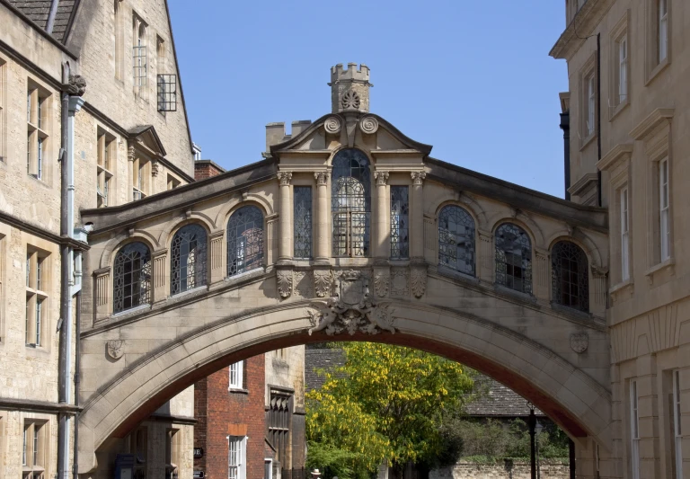 an arch and stone buildings in a courtyard