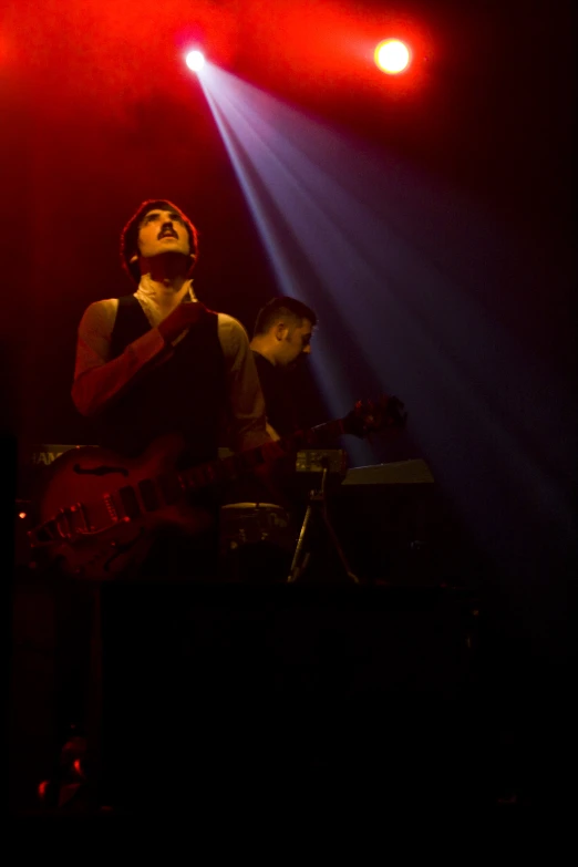 a person with a guitar on stage performing