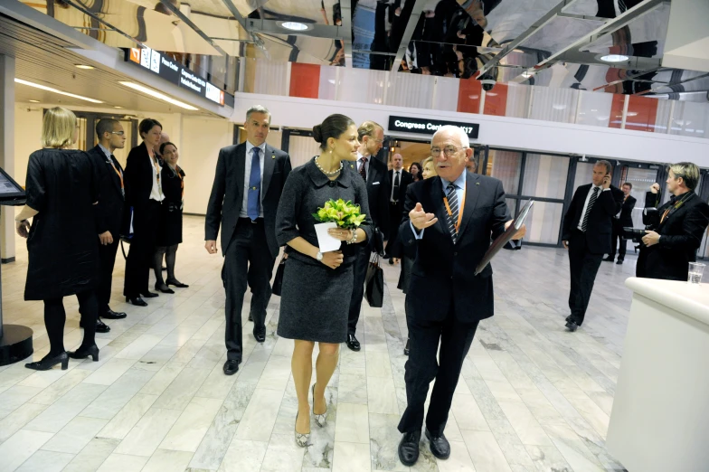 two woman are standing and talking in a building