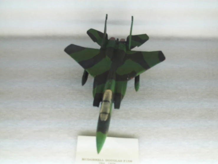 a fighter jet model with the green camouflage finish