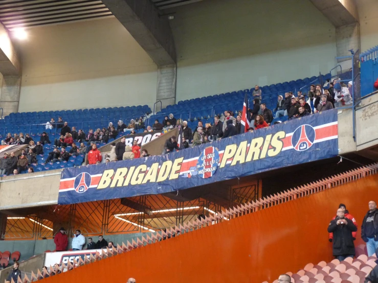 a group of people in the stands at a soccer game