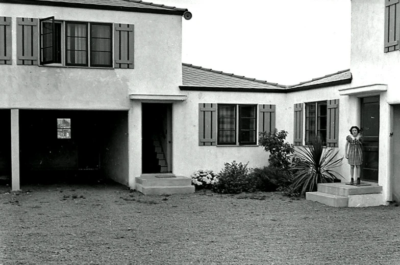 two buildings with two people standing outside one