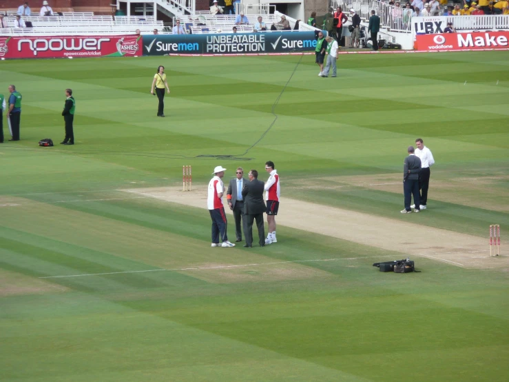 some people standing on a green grass field