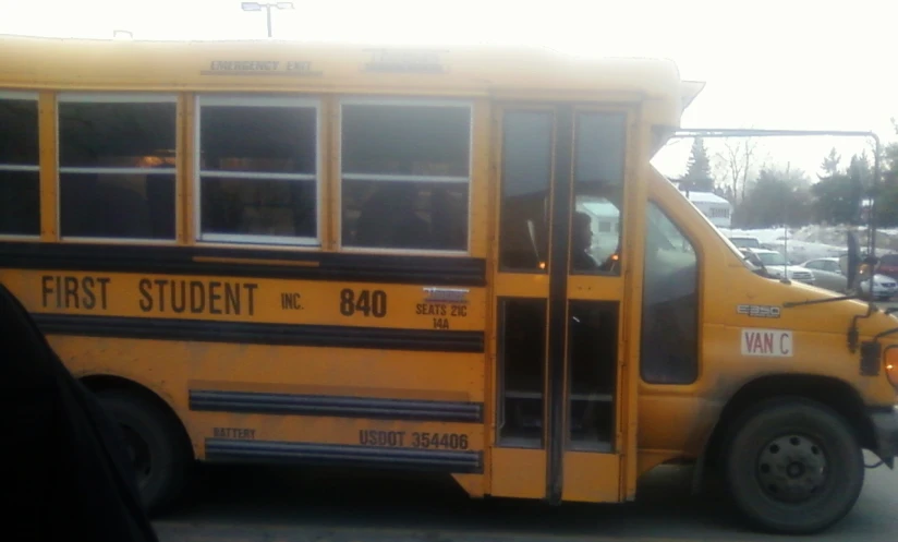 school bus driver waiting for school for students to enter