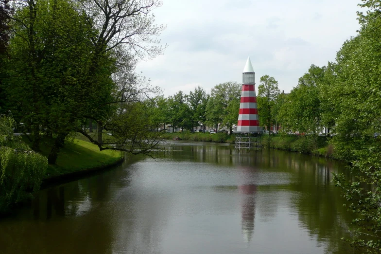 the light tower is surrounded by lush green trees