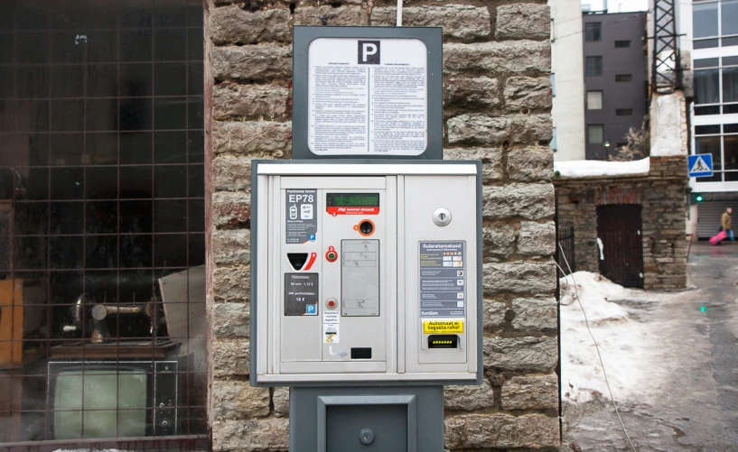a vending machine near a stone building in a city