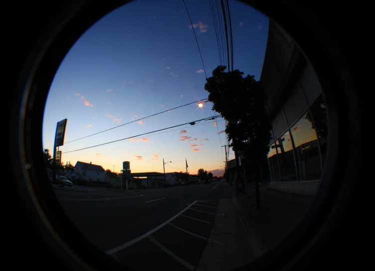 a view from the outside of a round window at dusk