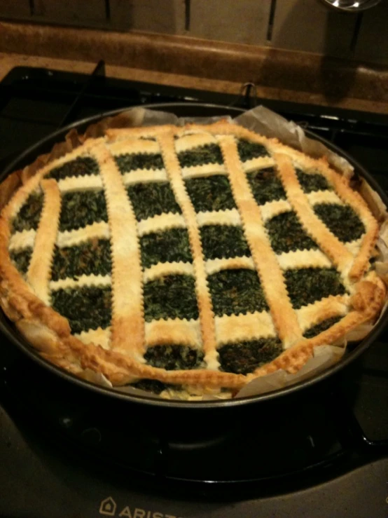 green and white pie is in a pan