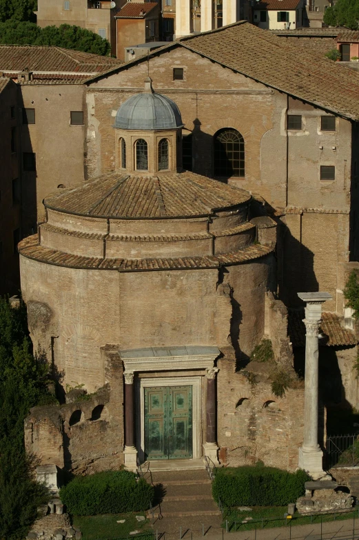 an old church with a steeple stands in a city