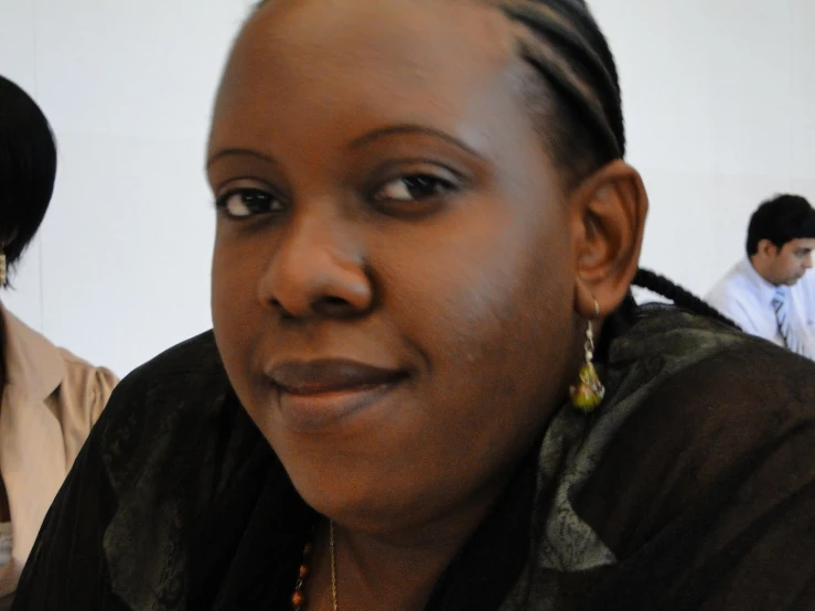 a woman with a pigtail id smiles at the camera