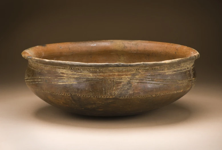 a close up of an old, wooden bowl
