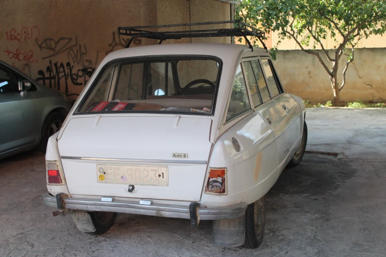 an older vehicle parked next to a younger one