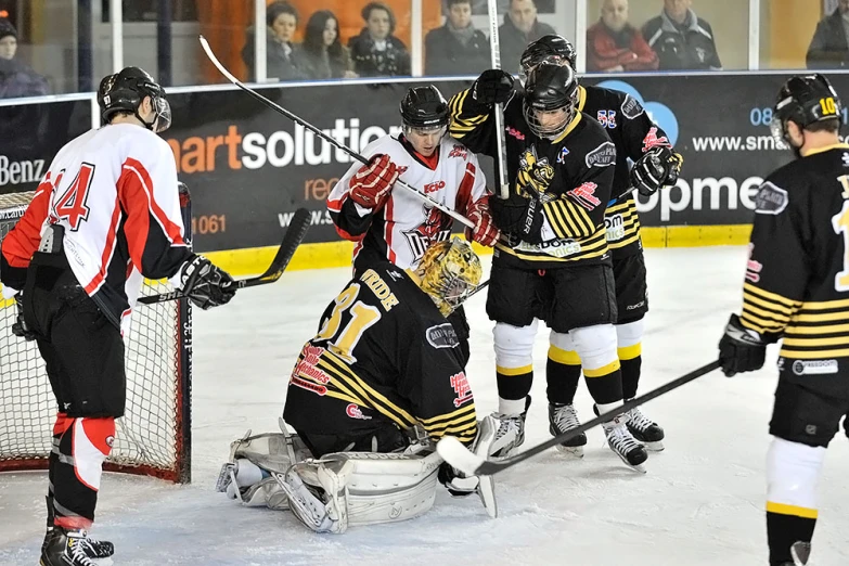 some ice hockey players playing on a rink