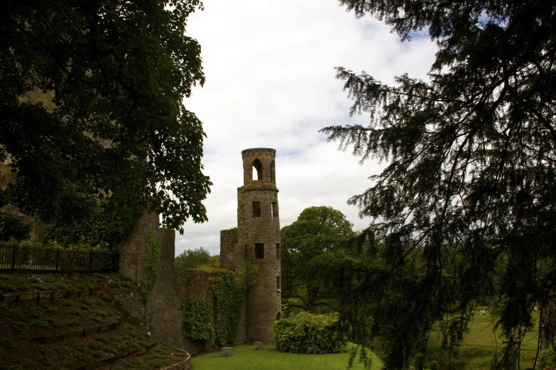 a castle tower with an open window on a hill