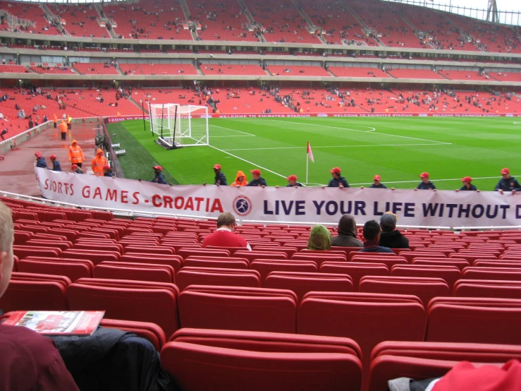 a big stadium with lots of people watching and playing a soccer game