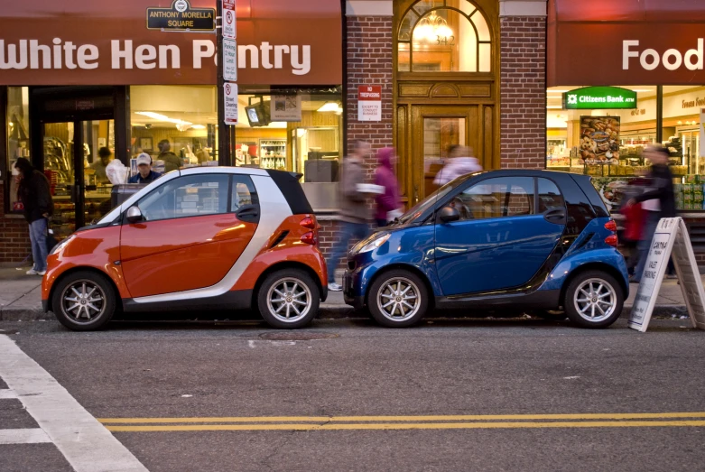 a small car with a larger one sitting beside it