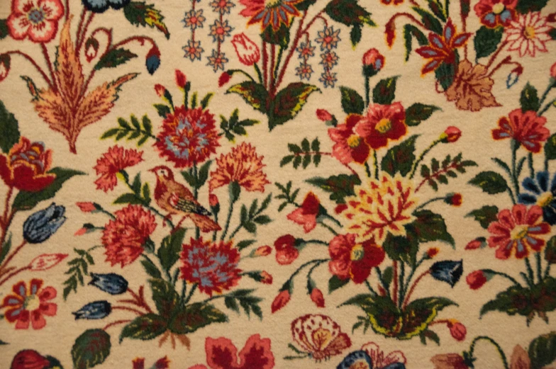 a red and yellow floral pattern is in the middle of a rug