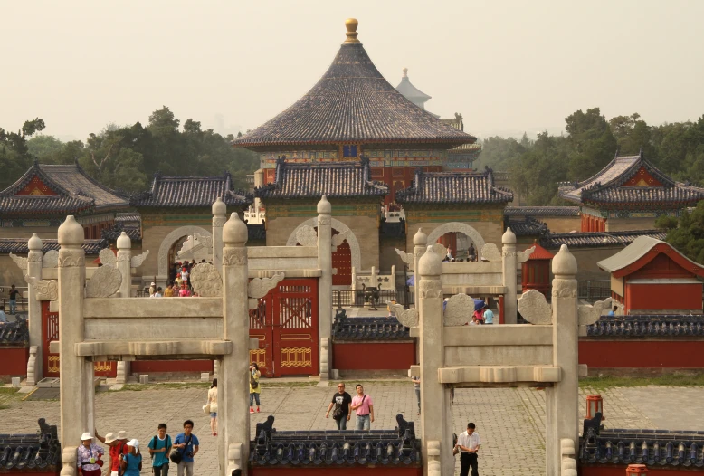 tourists walking around a park near a castle