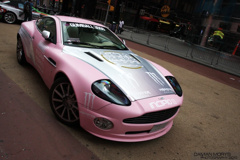 a pink and white car on the side of a road