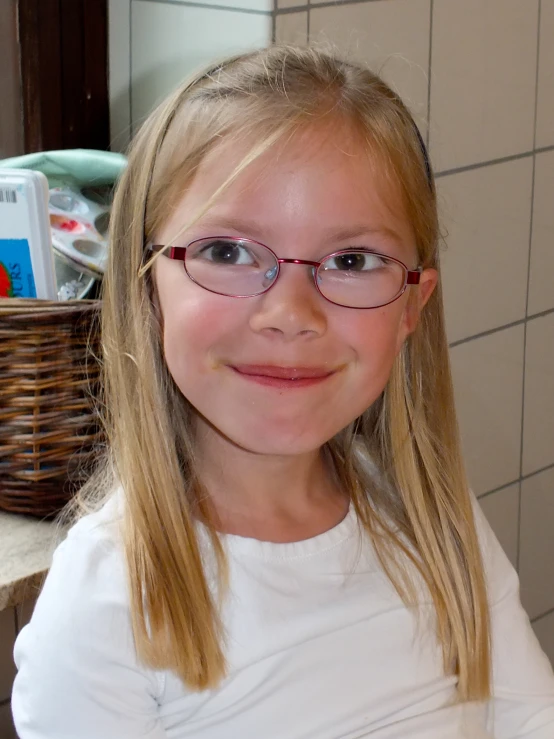 a girl with glasses posing for a picture