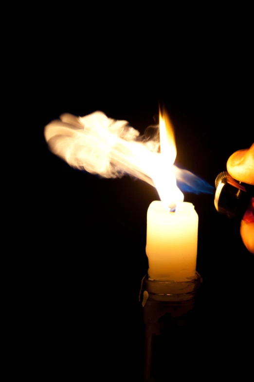 a lit candle being used to turn on