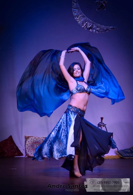 a woman is dressed up in a belly dancing costume