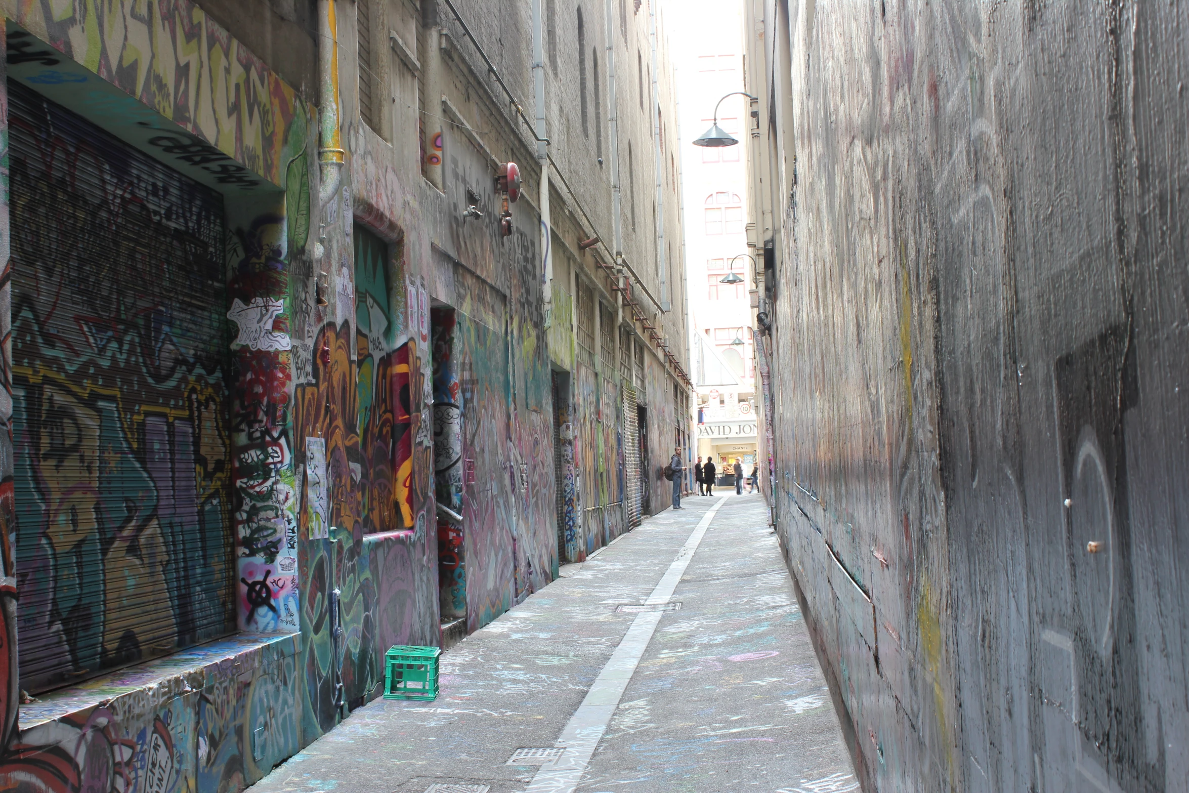 the alleyway is covered in colorful graffiti