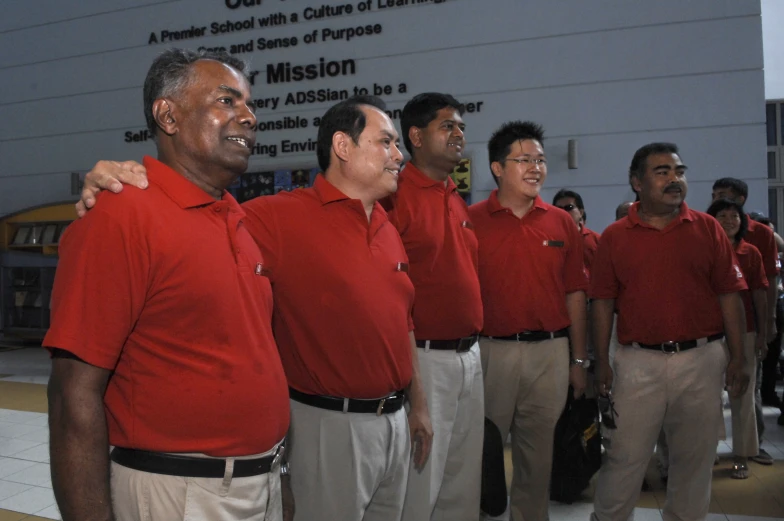 men standing together in front of a school