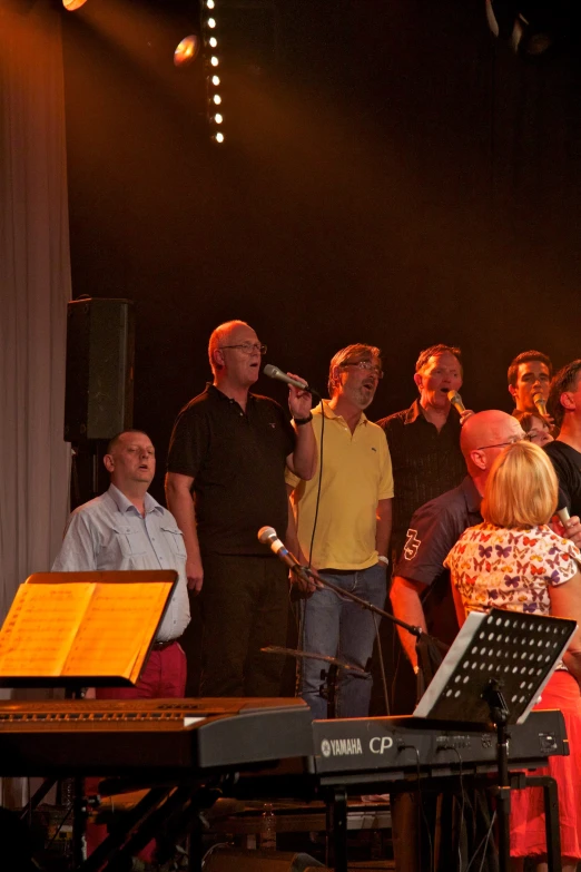 a large group of people sing and play music together