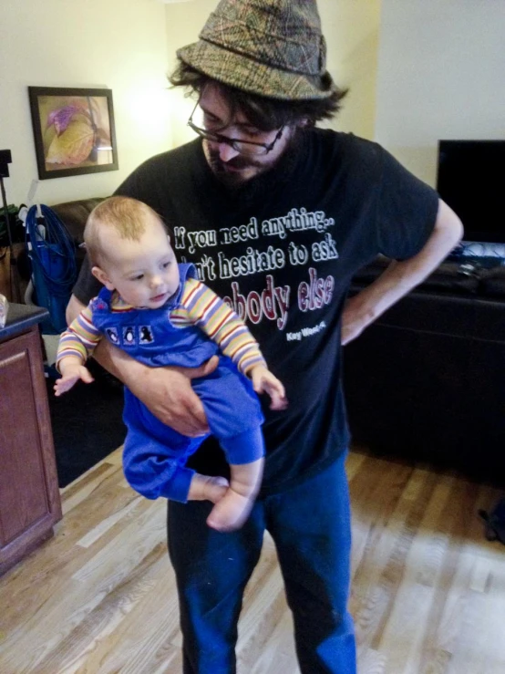 a man in glasses holding a baby